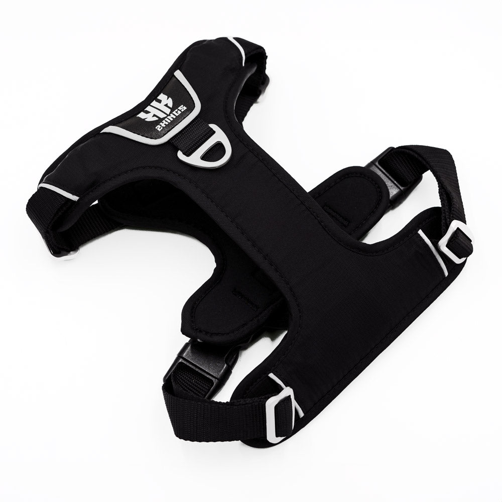Black padded dog harness, adjustable and waterproof, featuring a top handle for easy control and comfort during walks.