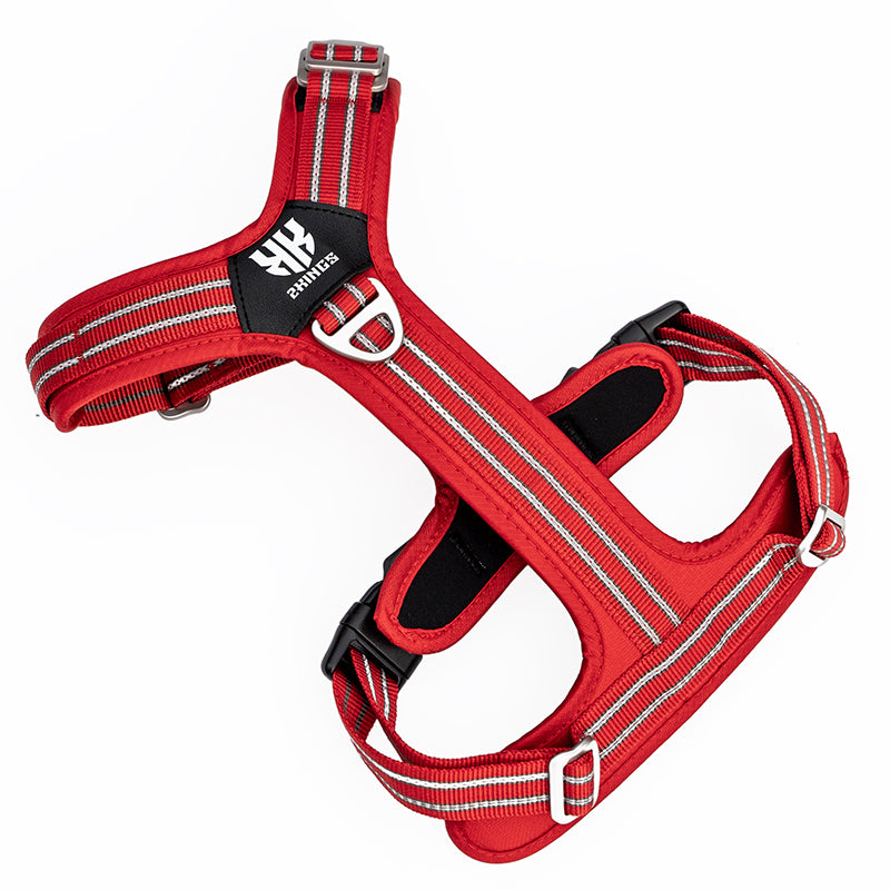 Lightweight, adjustable red dog harness with reflective stripes and secure buckles for safety.